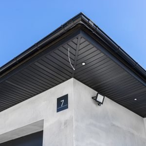 A modern graphite herringbone roof lining is attached to the trusses, visible turned on LED lights.
